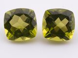 two square cut green quartz gems on a white background