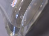 a close up of a glass vase with a banana in it