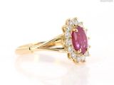 a close up view of a pink sapphire and diamond ring