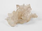 a close up of a cluster of clear crystals on a white surface