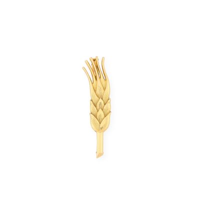 an image of a gold ear pin with wheat ears on it
