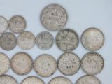 several silver coins are arranged in a triangle on a white surface