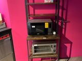 a microwave and a microwave oven on a shelf in a room