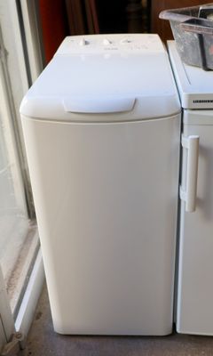 refrigerator and freezer sitting next to each other on the floor