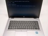 a laptop with a blue screen sitting on a table