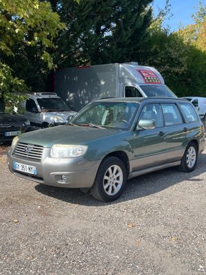 a picture of a car parked in a lot with a truck in the background