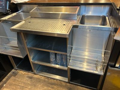 a stainless steel sink in the middle of a kitchen