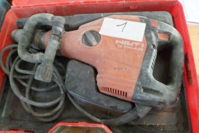 a red box with a tool in it that is sitting on a table