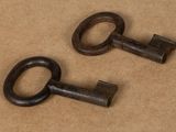 two old keys that are sitting on a table
