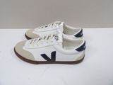 white and blue vejaa sneakers with brown soles on a white surface