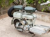 a motor scooter that is parked on the side of the road