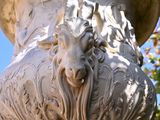 a large white vase with a lion head on it