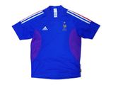 a blue shirt with a red and white stripe on the chest