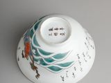 a white bowl with a design on it on a table