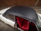 a white car with a black top and red seats