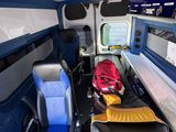 two seats in the back of a bus with a backpack on it