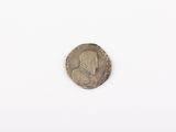 an old silver coin with a woman ' s face on it