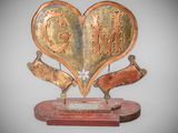 a sculpture of a heart with two people inside of it