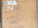 a cardboard box with a sticker on it sitting on the floor