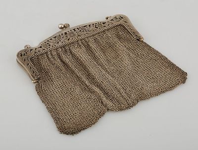 an old purse is sitting on a table with a chain around it