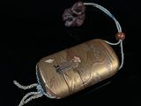 a small metal case with a rope around it