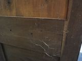 a close up of a wooden door with a hole in it