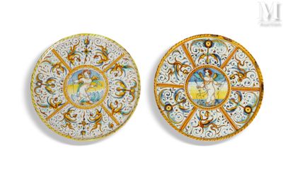 two plates with designs on them on a white surface