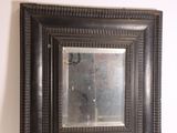 a picture of a mirror hanging on the wall