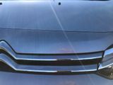 a close up of a car ' s front grill and headlight