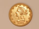 a close up of a gold coin with a woman ' s head on it