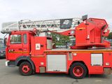 a red fire truck that is parked in a parking lot