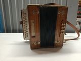an old accordion sitting on top of a table next to a wall