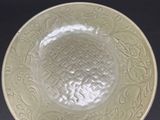 a close up of a bowl on a table with a black background