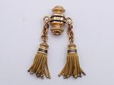 pair of gold tone earrings with tassels on a white background
