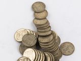 pile of old coins on a white background
