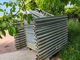 a pile of metal pipes sitting on the side of the road