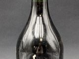 bottles of liquor are lined up on a table with a gray background