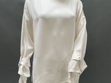 an image of a mannequin wearing a white dress with ruffled sleeves