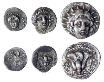 six ancient silver coins with faces and heads on them