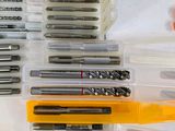 many different types of drill bits in a plastic box