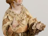 a figurine of a woman holding a bird in her hand