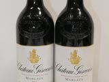 two bottles of wine that are sitting on a table