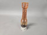 a vase that has a tree on it on a table