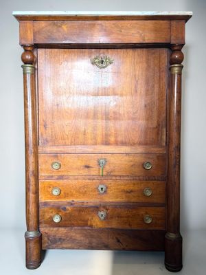 a wooden chest of drawers with brass hardware on it
