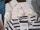 a lot of clothes that are sitting on a bed