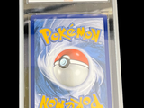 a pokemon card in a clear plastic holder on a table