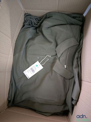 a box with a shirt inside of it that has a tag on it