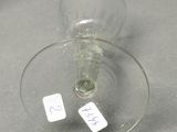 a wine glass with a label on it sitting on a table
