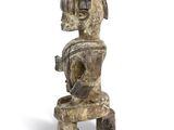 an old wooden statue of a man with a hat on his head