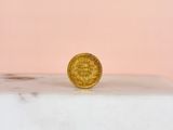 a gold coin sitting on top of a marble slab